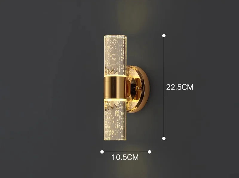 Brass bathroom wall sconce with 22.5cm height and 10.5cm width, featuring cylindrical bubble acrylic lights.
