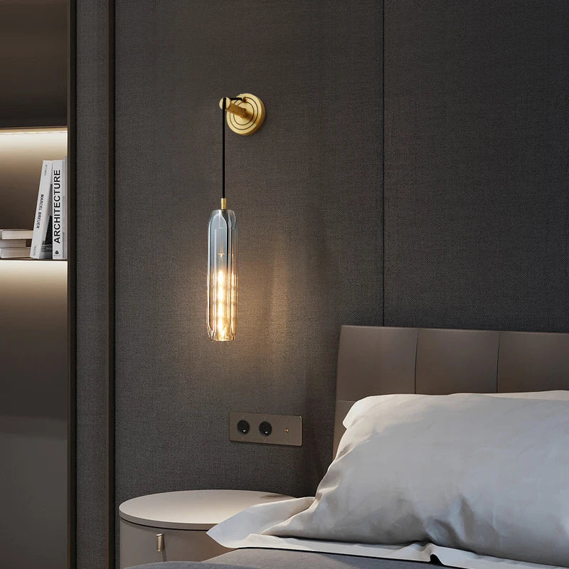 brass crystal rod wall sconce mounted near bedroom headboard