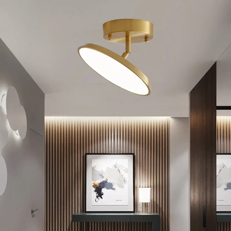 A sleek modern bathroom featuring a stylish circular light fixture hanging from the ceiling.