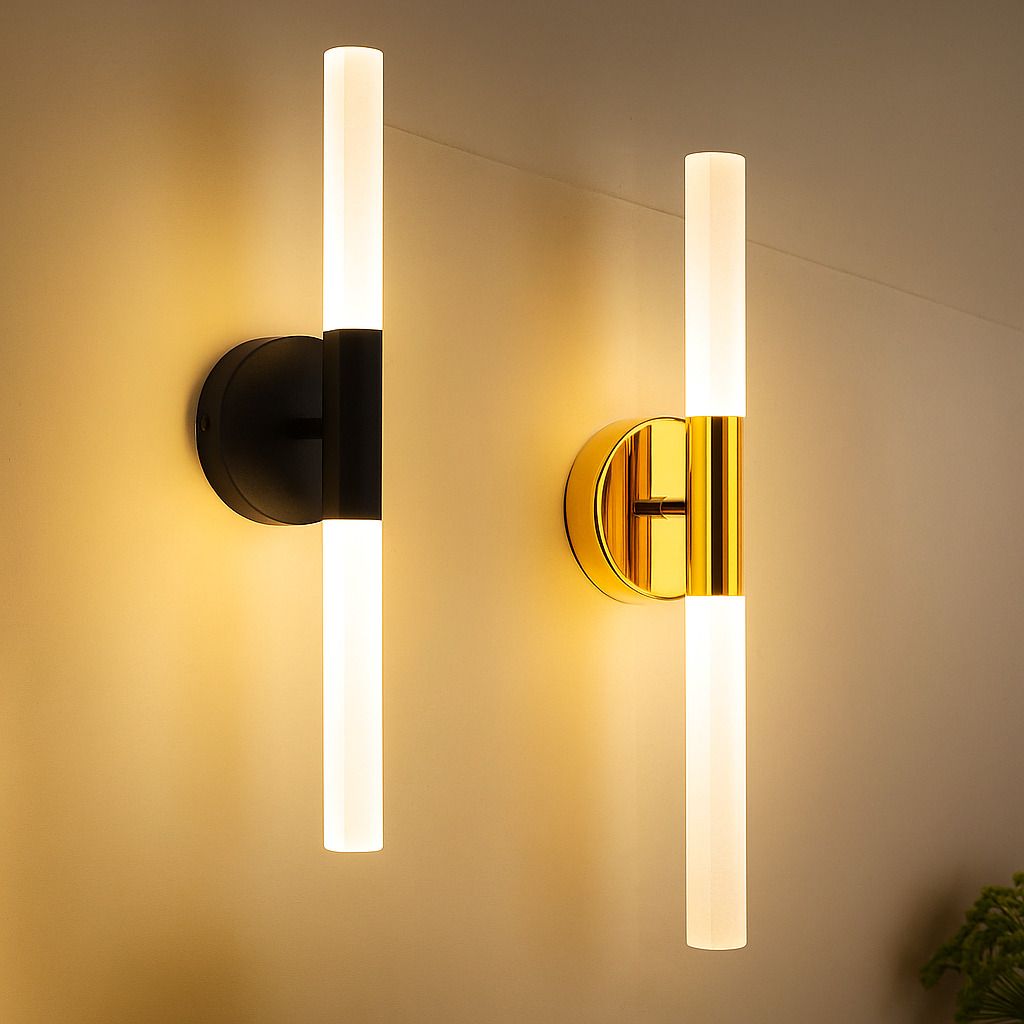 Modern bathroom featuring cylindrical LED wall sconces in matte black and brushed gold, providing soft vertical lighting beside mirrors and bathtub.
