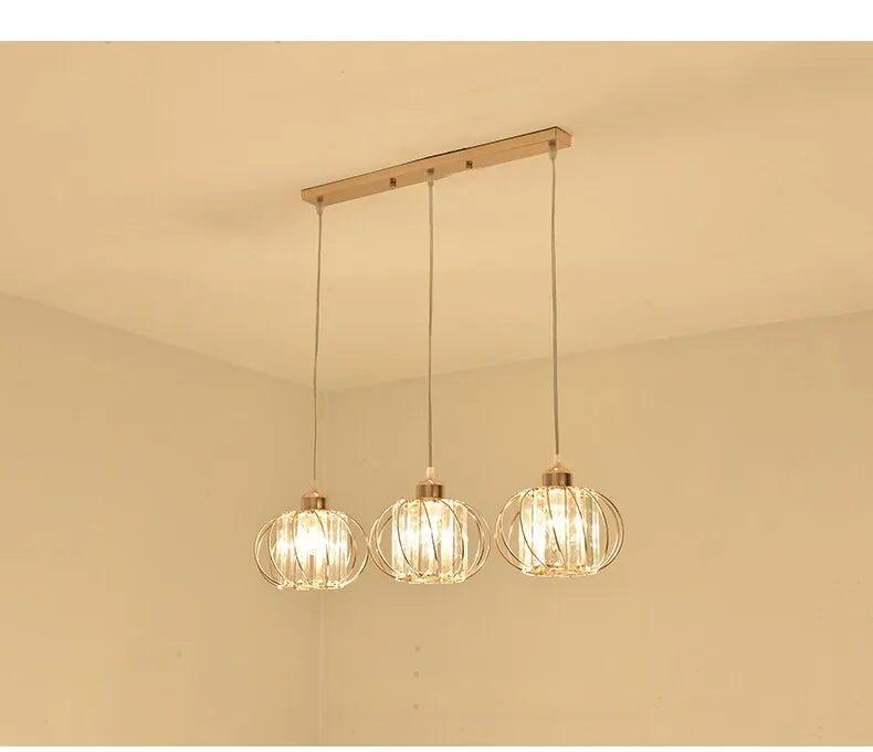 Three elegant light fixtures with clear glass orbs, perfect for brightening up a room with a trendy vibe.
