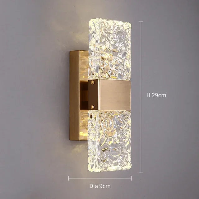 Gold wall sconce with dual textured glass bars and brushed gold base. Height 29cm, diameter 9cm. Sleek modern design ideal for hallways, bedrooms, or contemporary bathrooms.