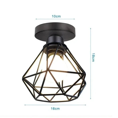Compact black metal cage ceiling light with geometric frame and soft white globe bulb, 16cm diameter.