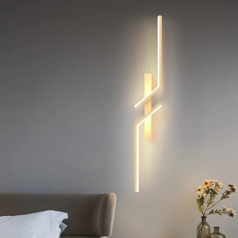 Sleek modern LED wall sconce with geometric light bars mounted on a bedroom wall, creating soft ambient lighting for a cozy atmosphere.
