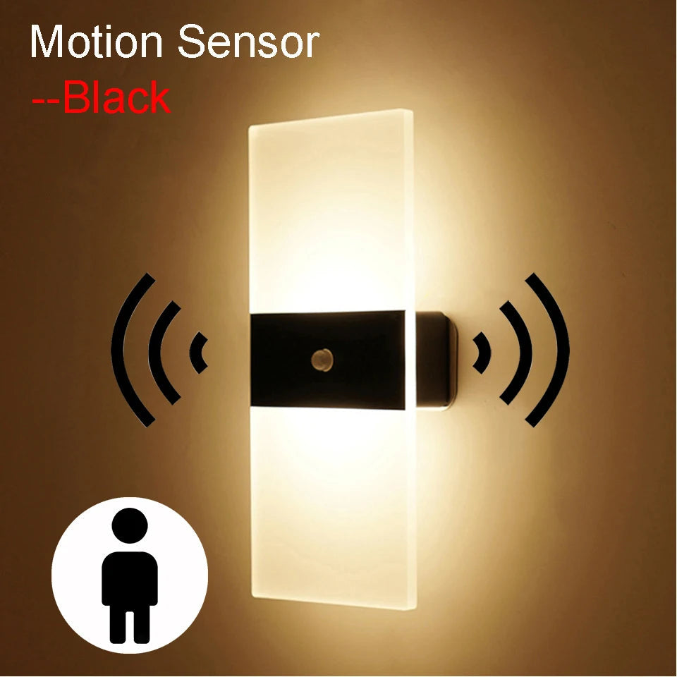 Modern rectangular wall sconce with built-in motion sensor, frosted LED panel, and black center trim, designed for automatic lighting in hallways or bedrooms.