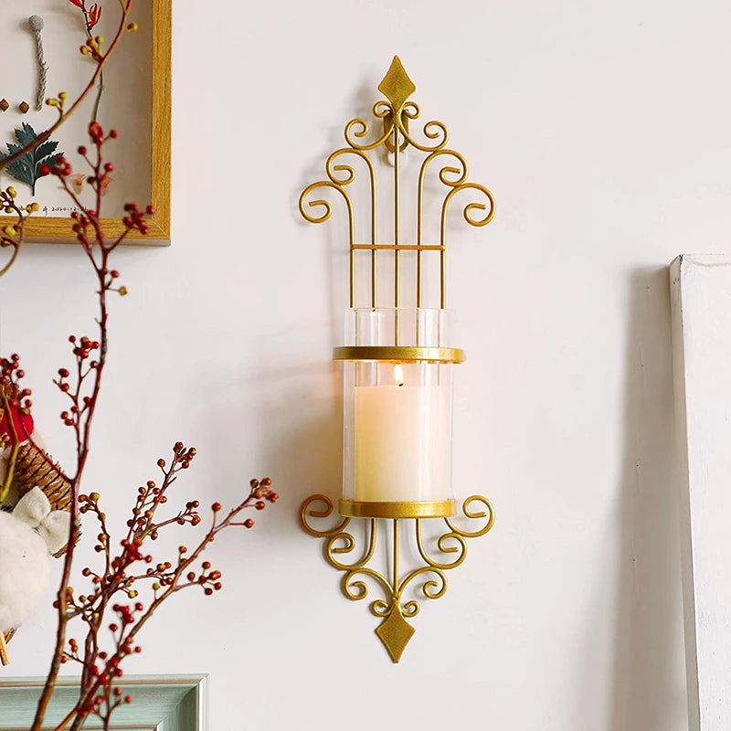 Ornate vintage-style gold wall candle sconce with scrollwork design and glass holder, ideal for home decor, ambient lighting, or festive accents.